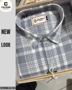A folded grey and white check shirt from Calibar Shirts, neatly packed in a premium box with fine detailing and button-up style.