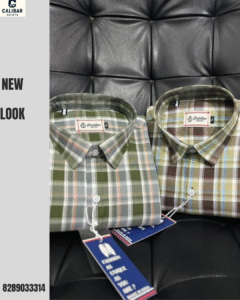 Calibar Shirts new checked collection in olive and brown tones neatly folded on leather background.